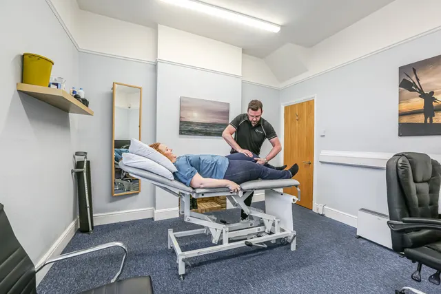 Physiotherapist treating a patient's lower back at Physio & More