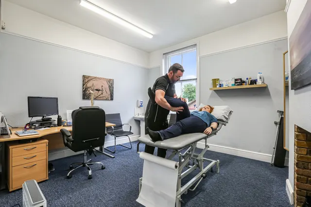 Physiotherapist assessing a patient's knee on the treatment couch at Physio & More
