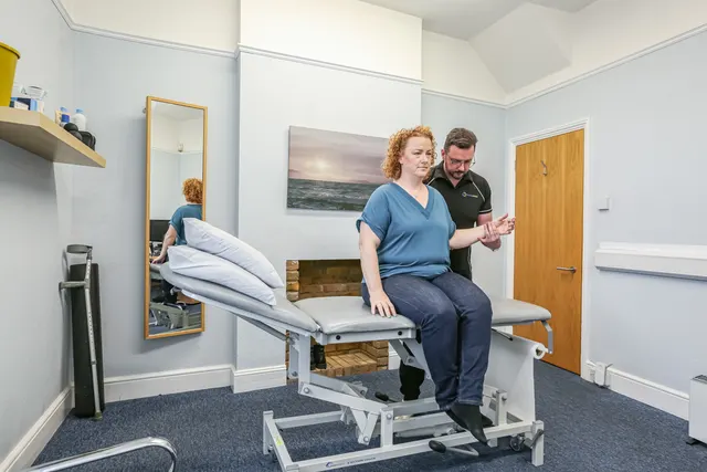 Physiotherapist assessing a patient's wrist and hand at Physio & More